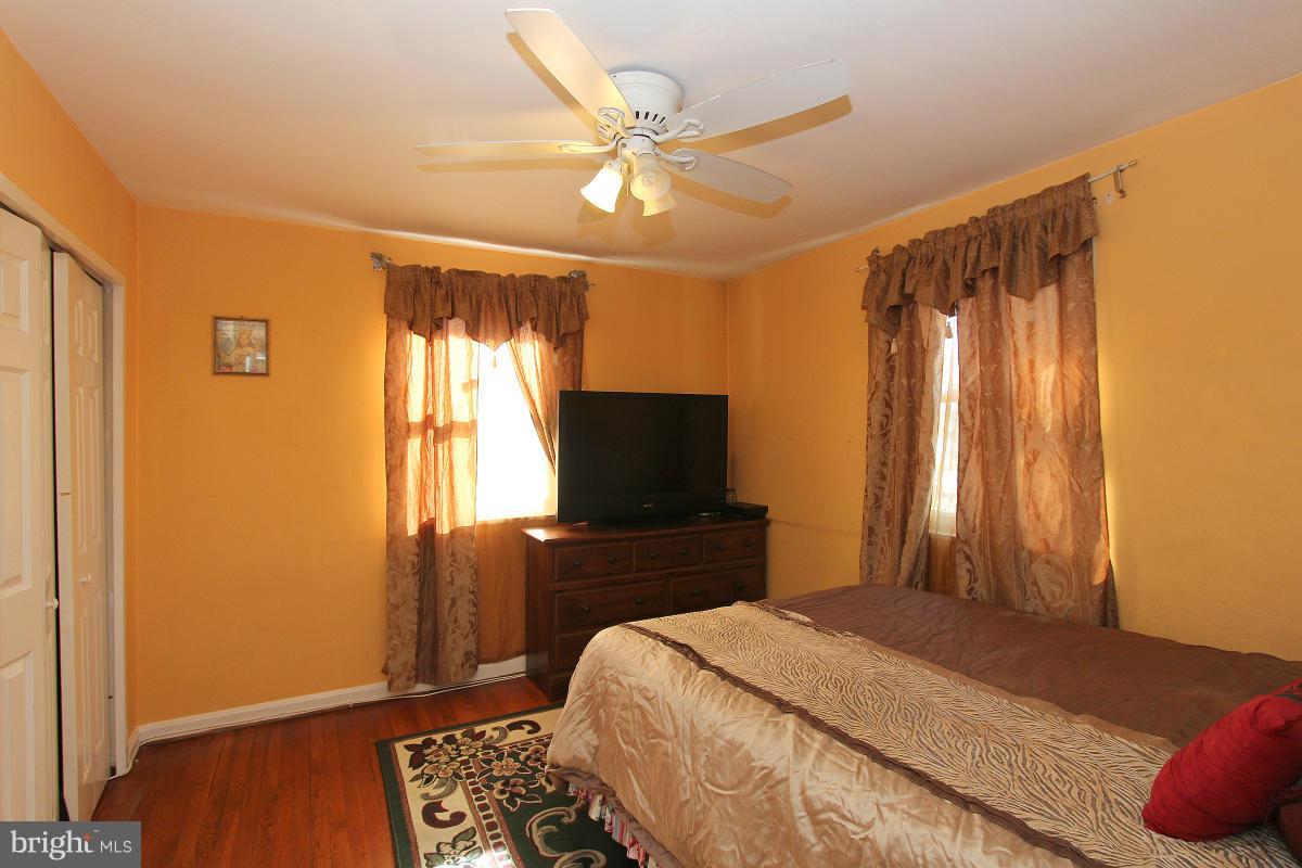 224 University Boulevard East Silver Spring, MD 20901 - Photo 14 of 30 a bedroom with a bed and a flat screen tv