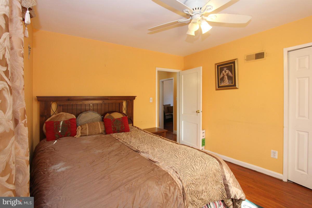 224 University Boulevard East Silver Spring, MD 20901 - Photo 15 of 30 a bedroom with a large bed and a chandelier