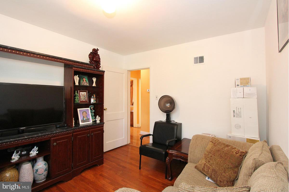 224 University Boulevard East Silver Spring, MD 20901 - Photo 16 of 30 a living room with furniture and a flat screen tv