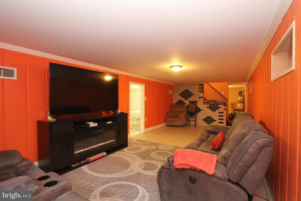224 University Boulevard East Silver Spring, MD 20901 - Photo 21 of 30 a living room with furniture and a flat screen tv
