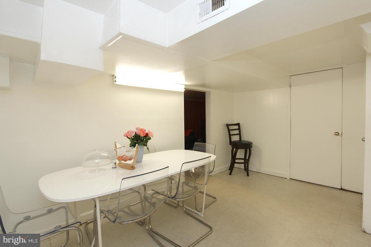 224 University Boulevard East Silver Spring, MD 20901 - Photo 26 of 30 a view of a dining room with furniture and a potted plant