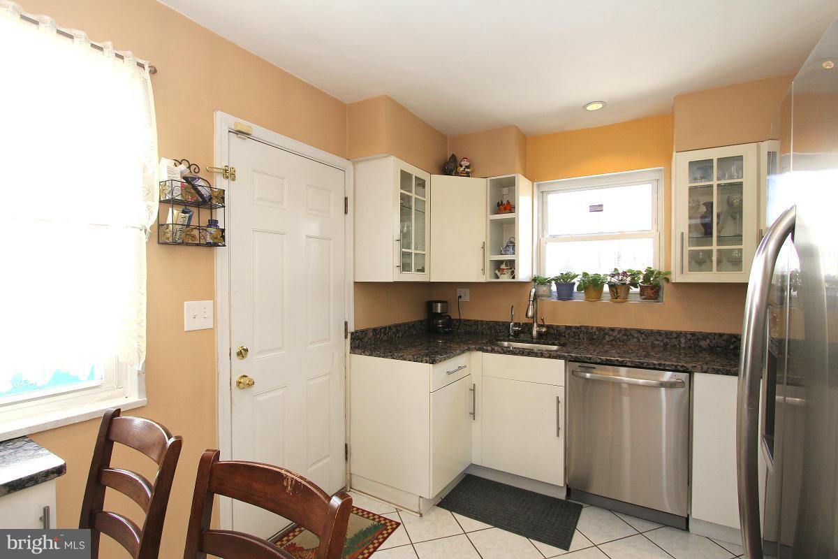 224 University Boulevard East Silver Spring, MD 20901 - Photo 10 of 30 a kitchen with stainless steel appliances granite countertop a sink and cabinets