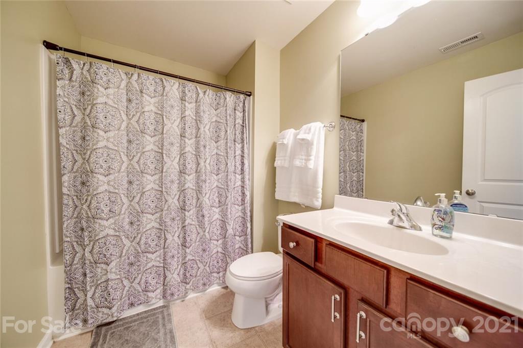 611 Old Mill Road Clover, SC 29710 - Photo 22 of 27 a bathroom with a sink a toilet and shower curtain