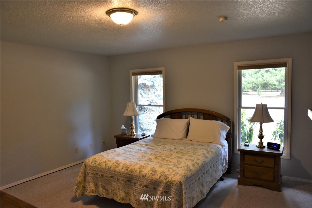 7303 Creekside Lane Southwest Rochester, WA 98579 - Photo 14 of 36 a bedroom with a bed and window