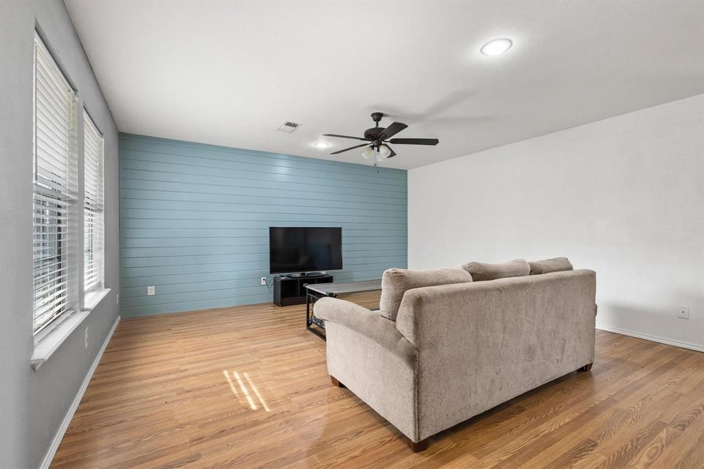 1223 Yowell Road Whitesboro, TX 76273 - Photo 11 of 30 a living room with furniture and a flat screen tv