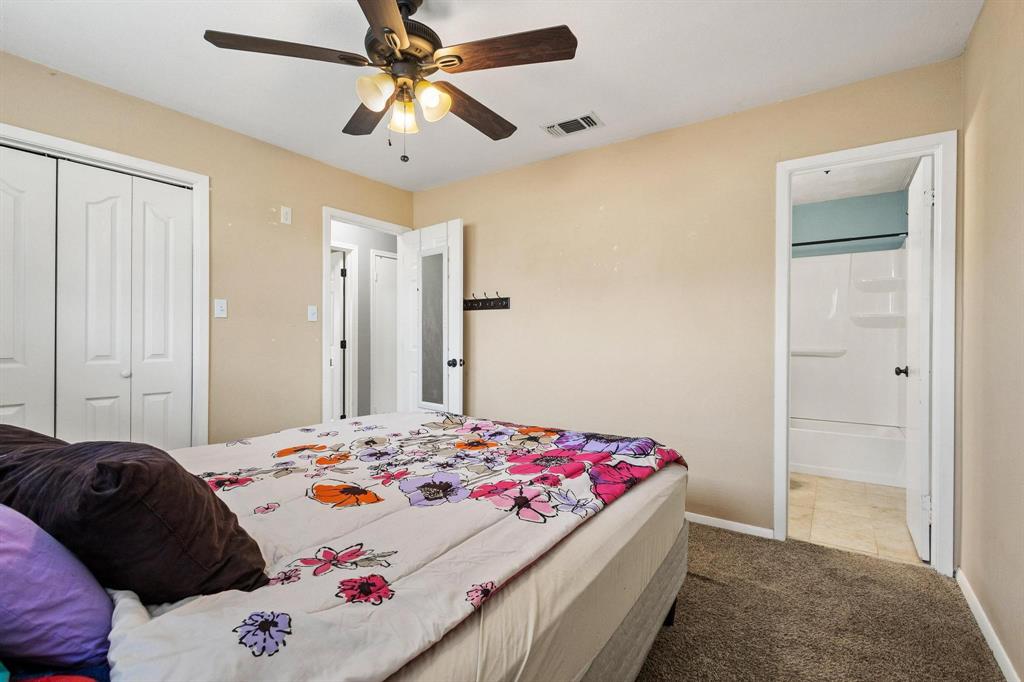 1223 Yowell Road Whitesboro, TX 76273 - Photo 13 of 30 a bedroom with a bed and a chandelier