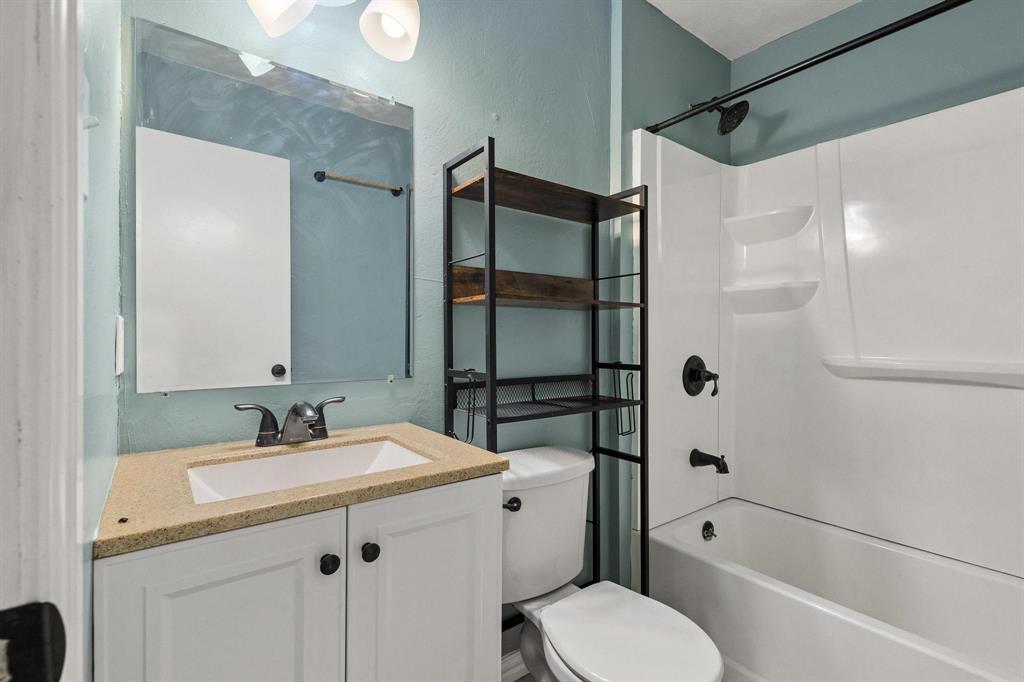 1223 Yowell Road Whitesboro, TX 76273 - Photo 14 of 30 a bathroom with a sink toilet and shower