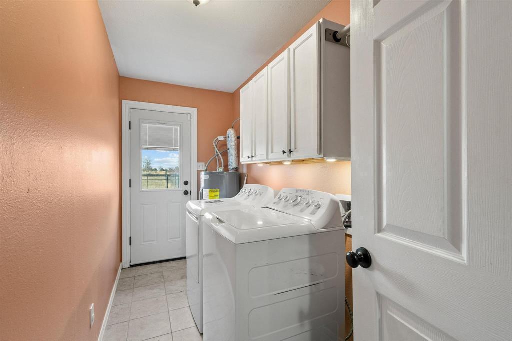1223 Yowell Road Whitesboro, TX 76273 - Photo 19 of 30 a bathroom with a granite countertop sink and a mirror