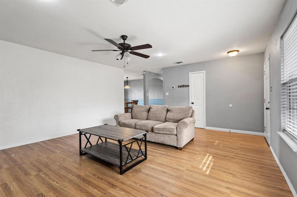 1223 Yowell Road Whitesboro, TX 76273 - Photo 10 of 30 a living room with furniture and a wooden floor