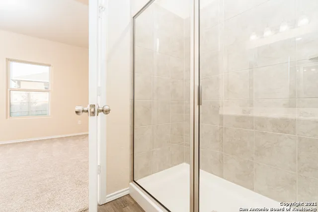 a bathroom with a glass shower door