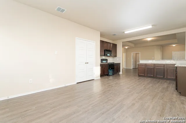 a view of a kitchen with a sink and a refrigerator