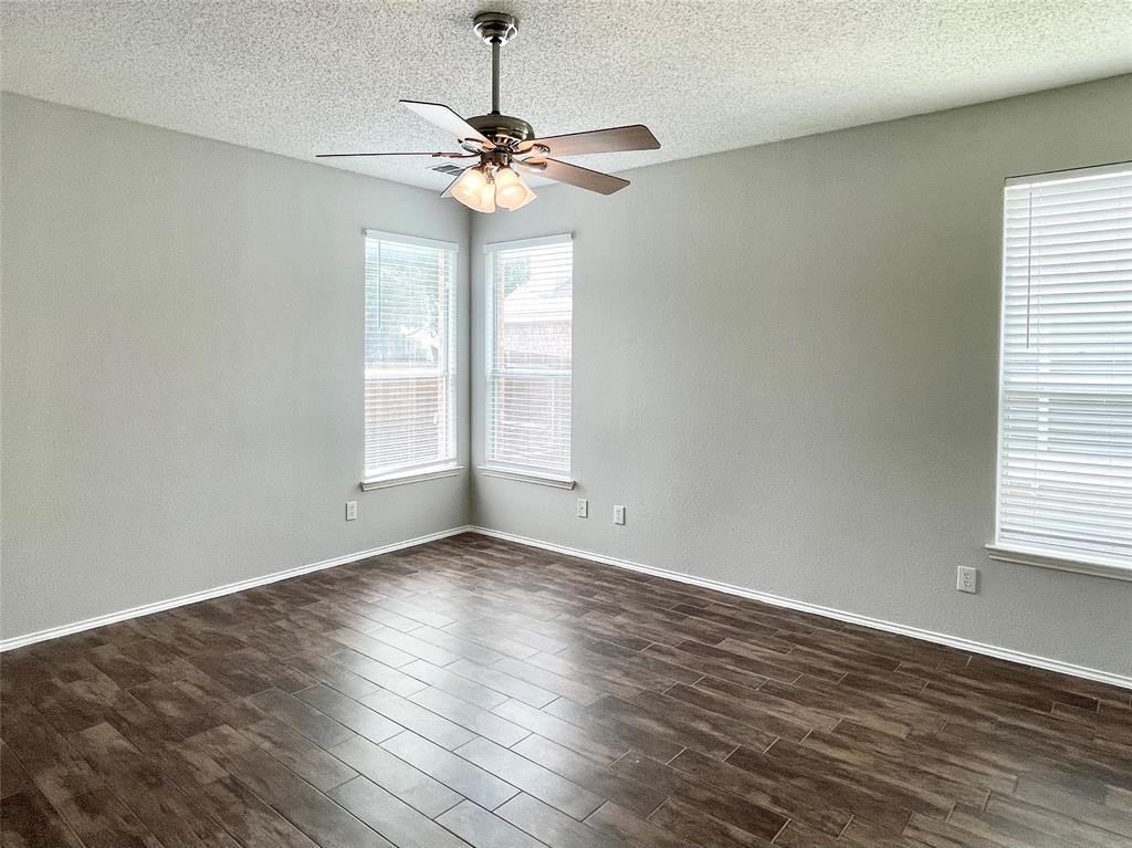 7205 Prairie Flower Lane Frisco, TX 75033 - Photo 11 of 23 a view of an empty room with wooden floor and a window