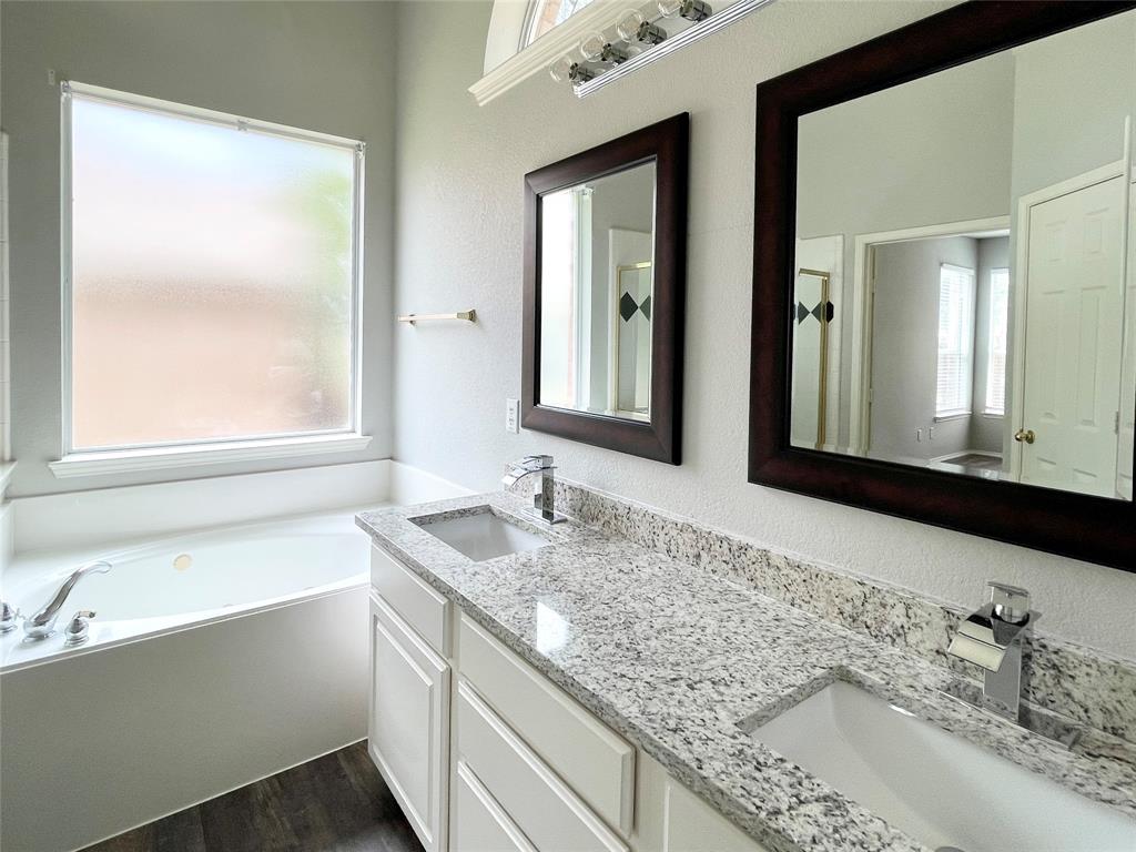 7205 Prairie Flower Lane Frisco, TX 75033 - Photo 13 of 23 a bathroom with a granite countertop sink and a mirror