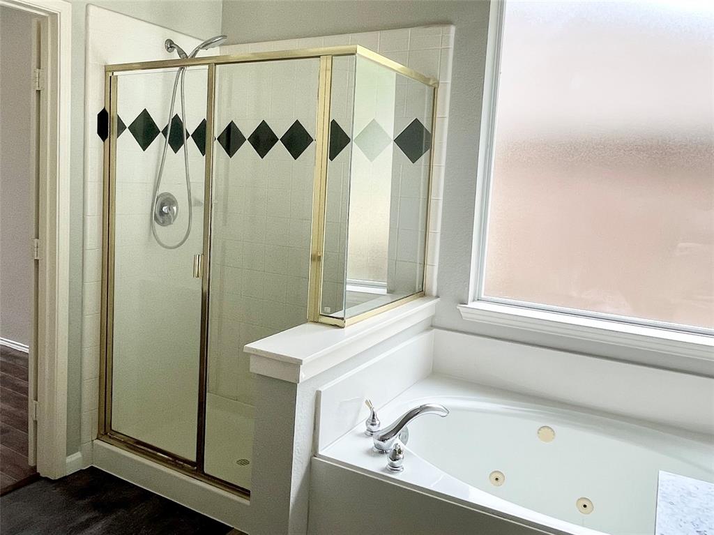 7205 Prairie Flower Lane Frisco, TX 75033 - Photo 14 of 23 a bathroom with a shower and a tub