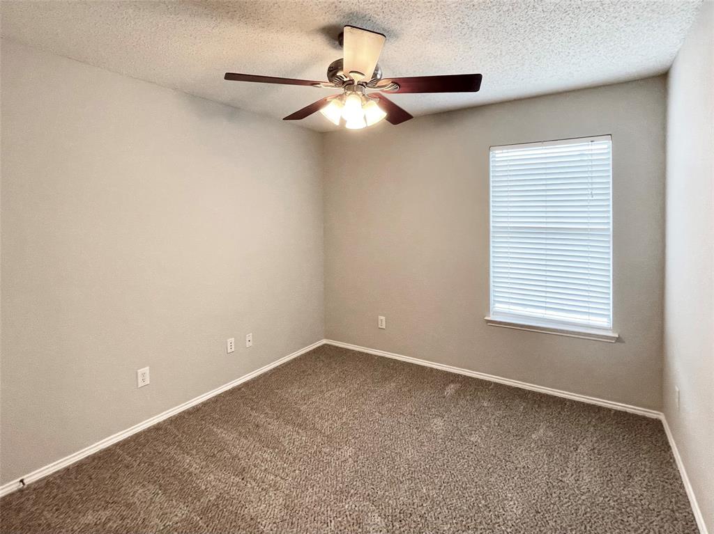 7205 Prairie Flower Lane Frisco, TX 75033 - Photo 17 of 23 an empty room with a window and a fan
