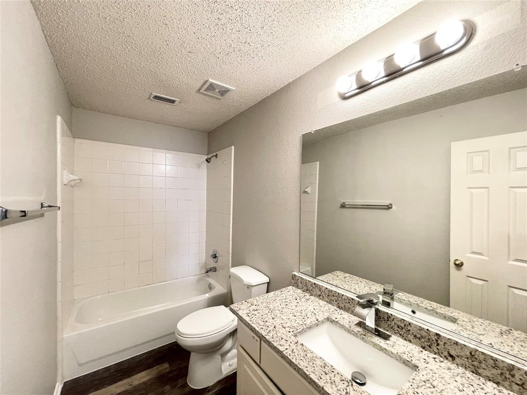 7205 Prairie Flower Lane Frisco, TX 75033 - Photo 20 of 23 a bathroom with a granite countertop sink toilet and shower