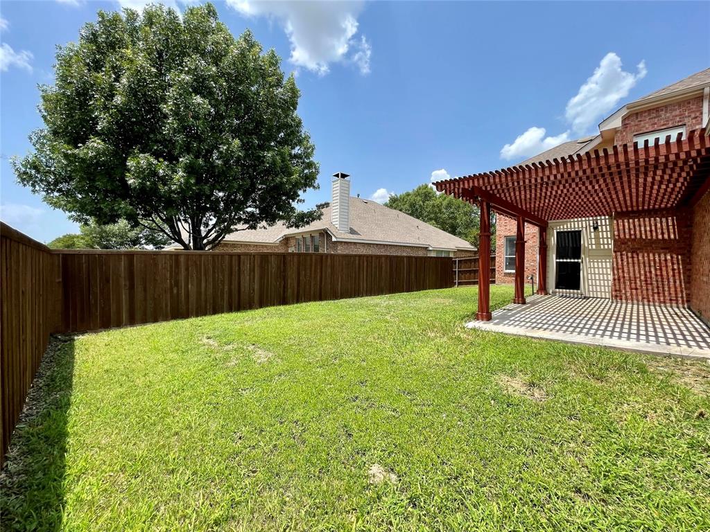 7205 Prairie Flower Lane Frisco, TX 75033 - Photo 22 of 23 a view of a backyard with a garden and deck
