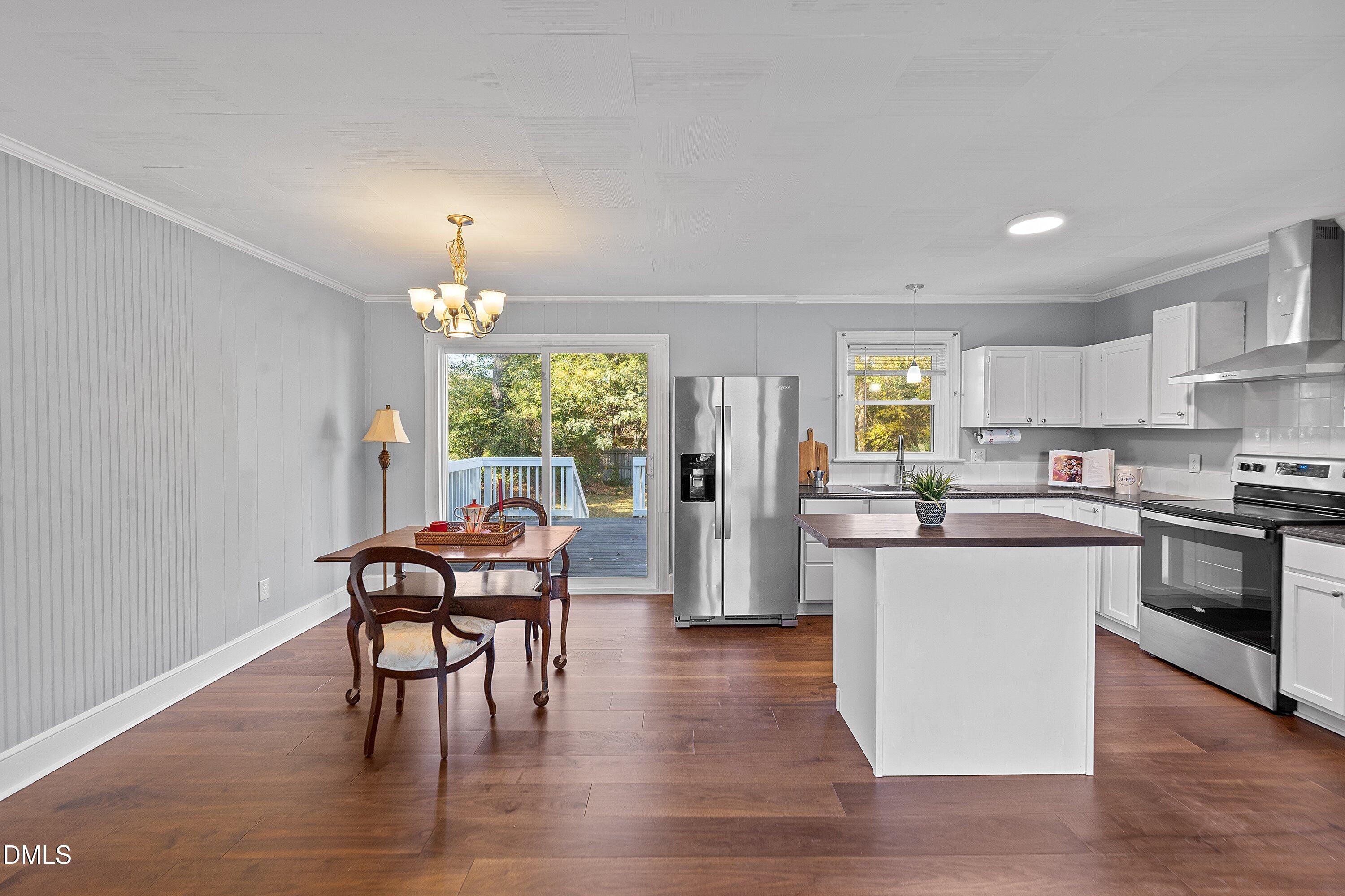 506 West Branch Street Spring Hope, NC 27882 - Photo 13 of 42 a kitchen with stainless steel appliances wooden floors and white walls