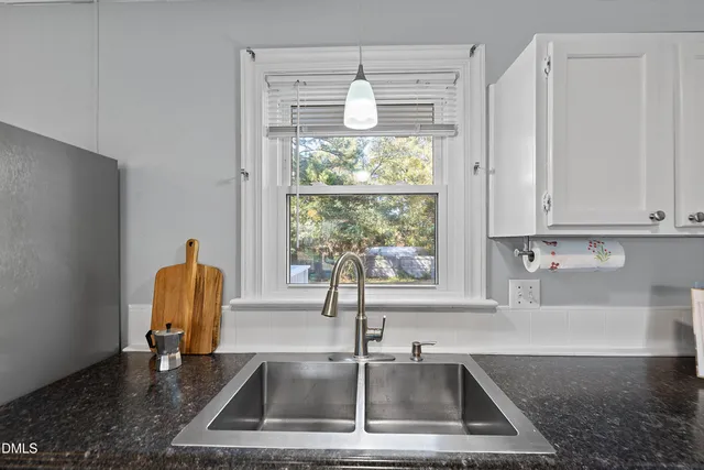 a kitchen with a sink and a window