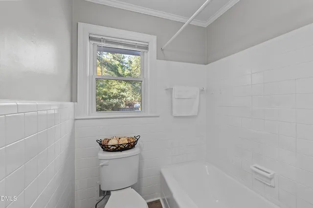 a bathroom with a toilet a sink and a window