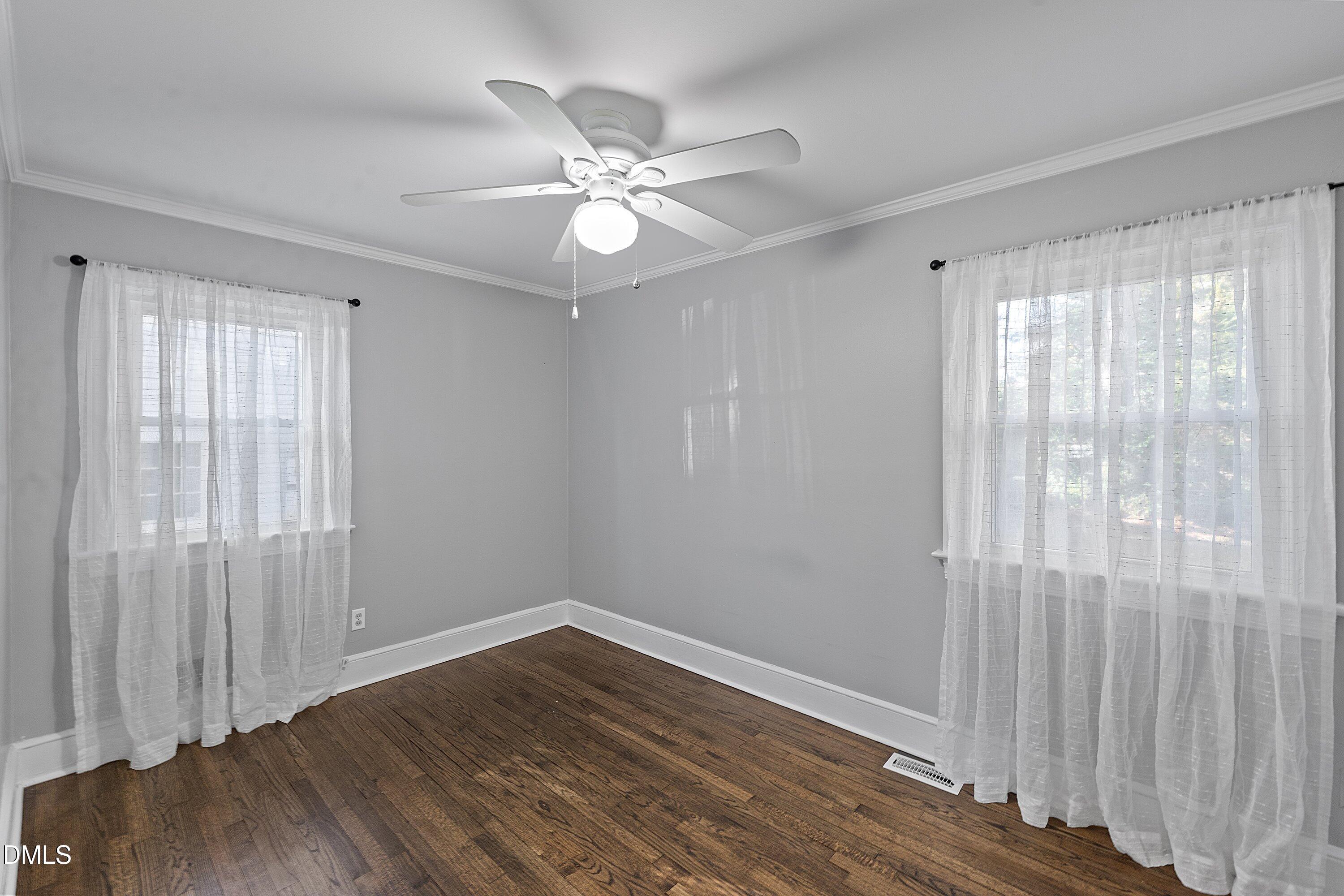 506 West Branch Street Spring Hope, NC 27882 - Photo 25 of 42 a view of an empty room with wooden floor and a window