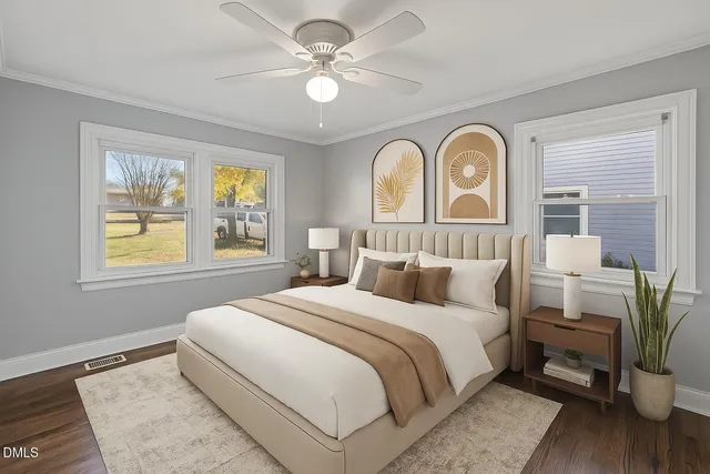 a bedroom with a large bed and a chandelier