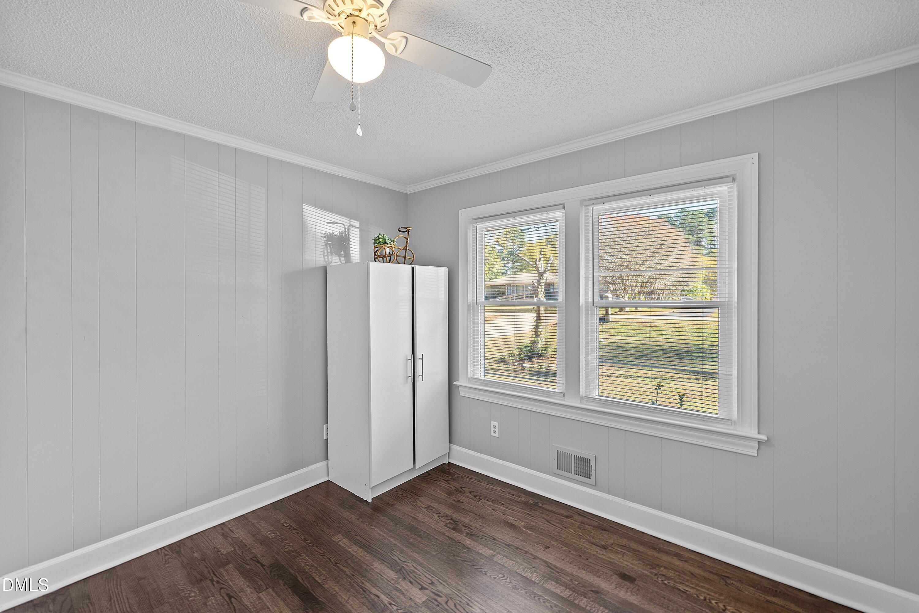 506 West Branch Street Spring Hope, NC 27882 - Photo 32 of 42 an empty room with wooden floor and windows
