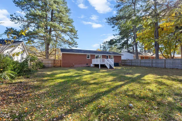 a view of a house with a yard garage and tree