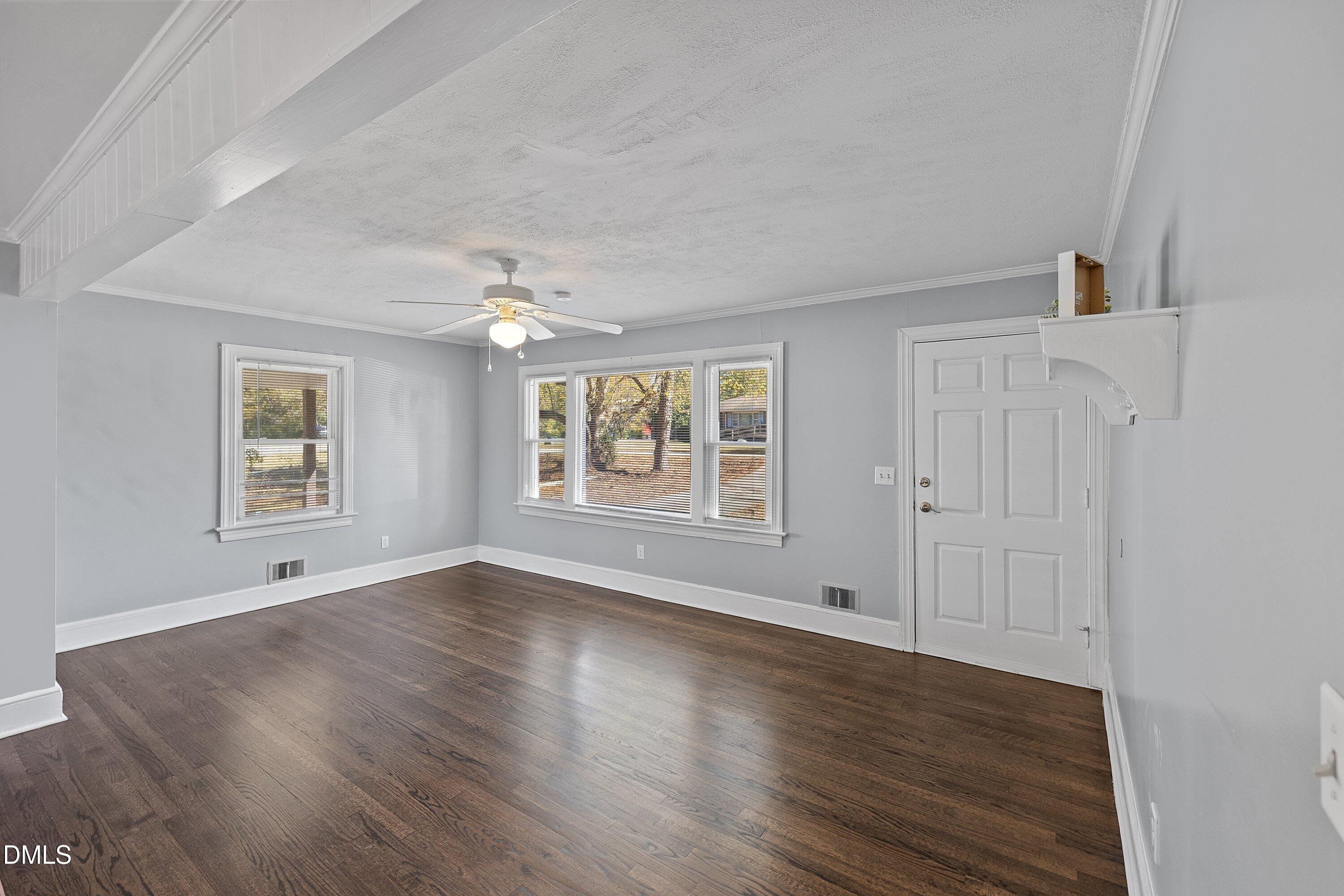506 West Branch Street Spring Hope, NC 27882 - Photo 9 of 42 a view of an empty room with wooden floor and a window