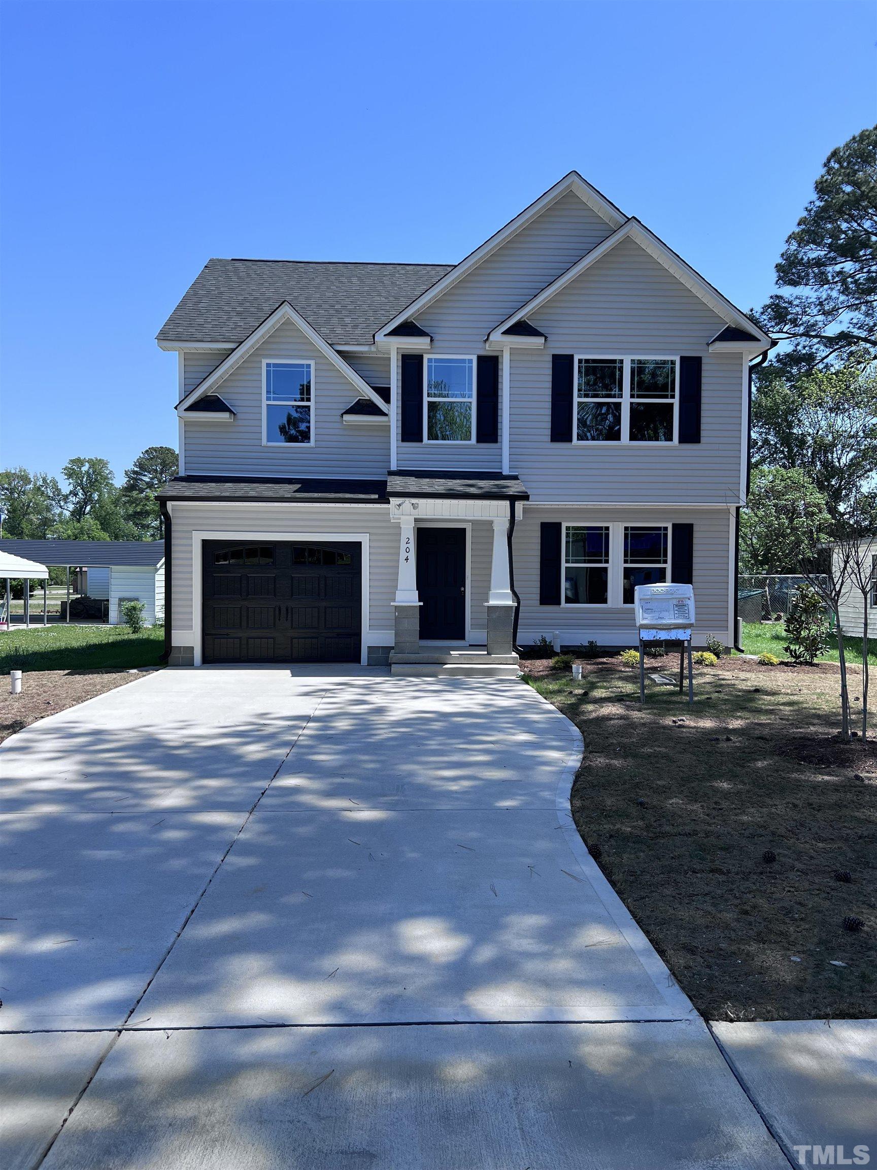 204 West Main Street Micro, NC 27576 - Photo 2 of 14 a front view of a house with yard and parking
