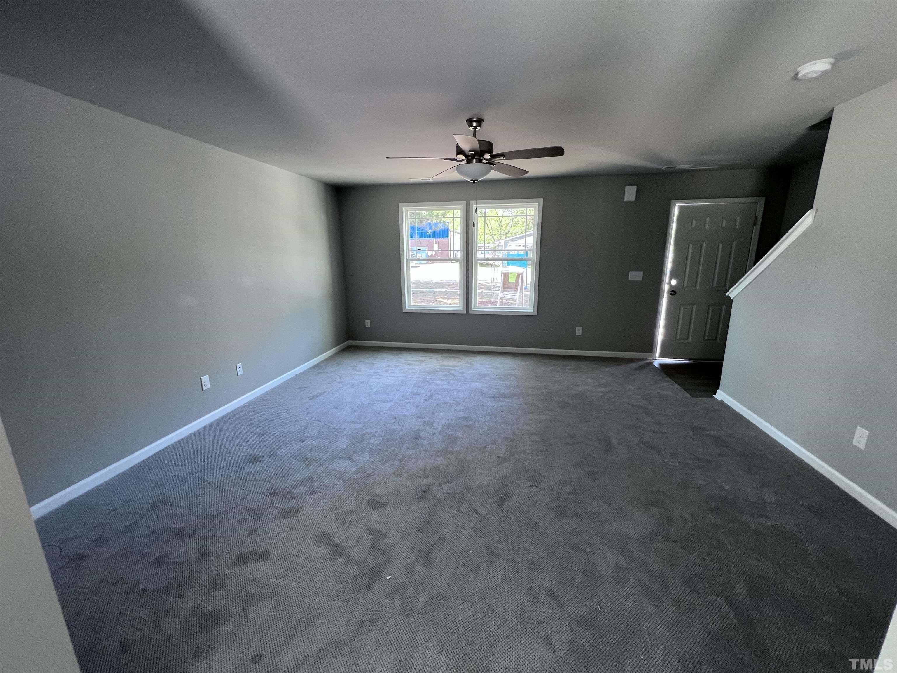 204 West Main Street Micro, NC 27576 - Photo 3 of 14 en empty room with windows and ceiling fan