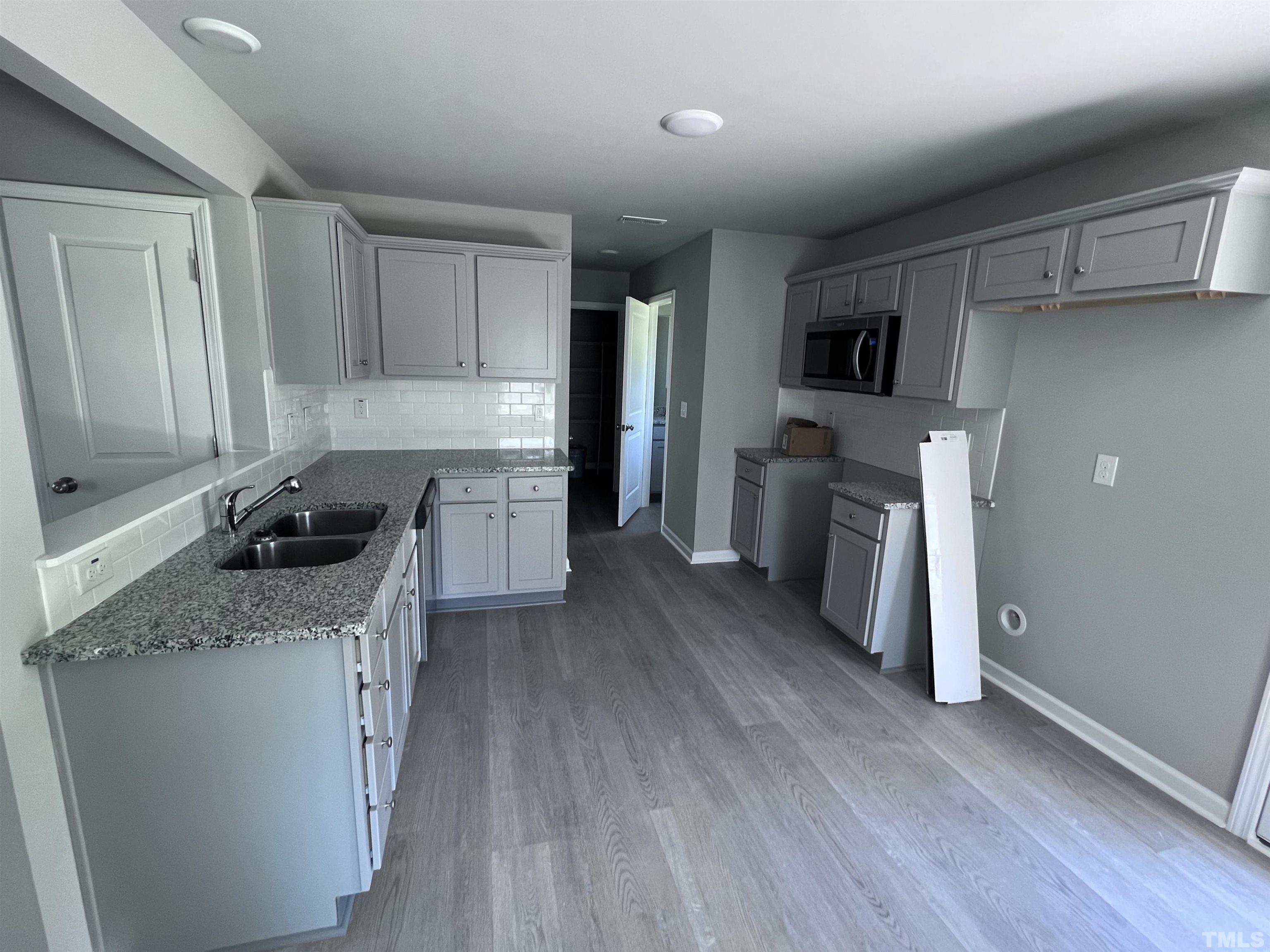 204 West Main Street Micro, NC 27576 - Photo 5 of 14 a kitchen with a sink a refrigerator and cabinets