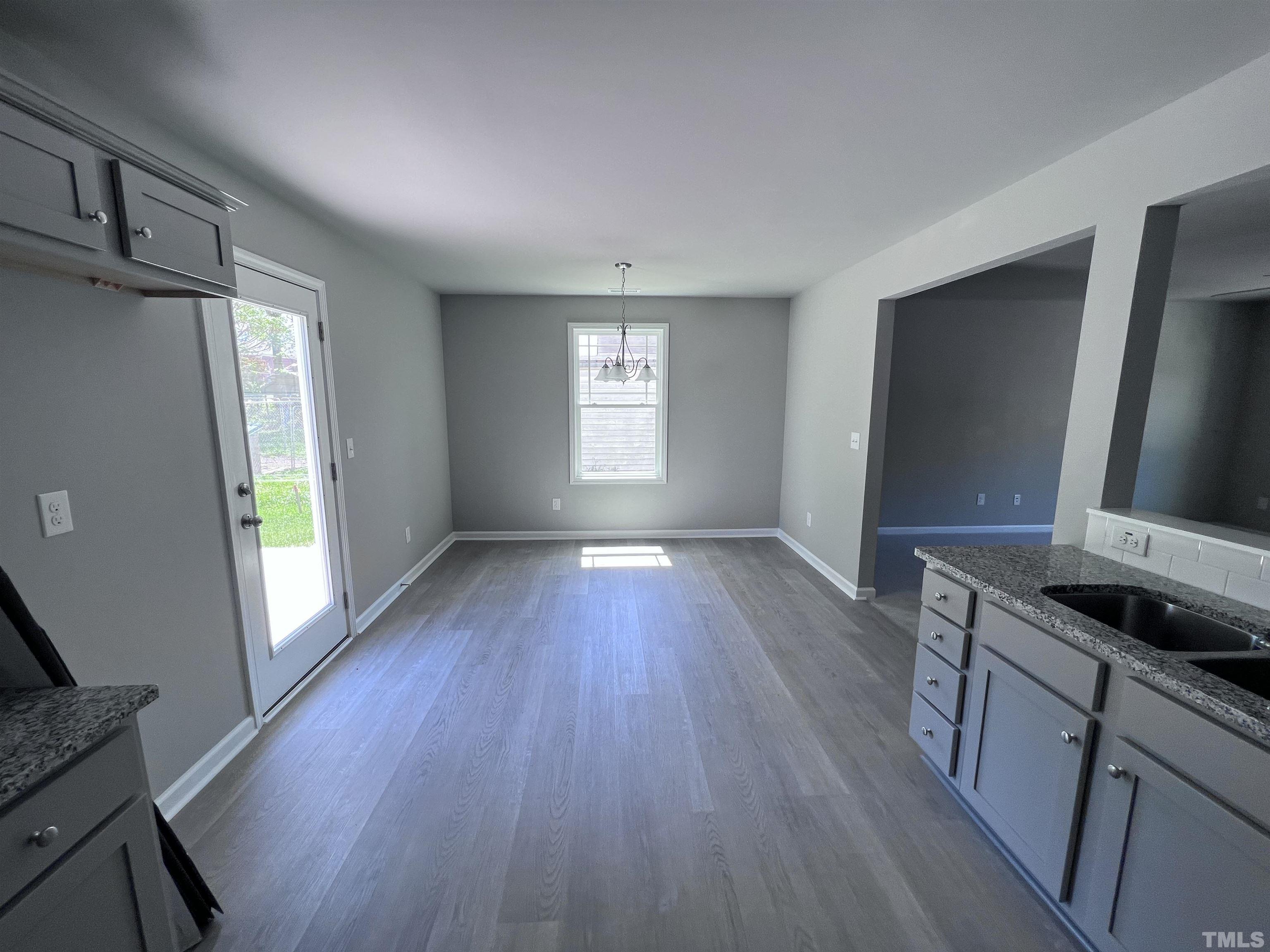 204 West Main Street Micro, NC 27576 - Photo 6 of 14 a kitchen with granite countertop wooden floors and sink