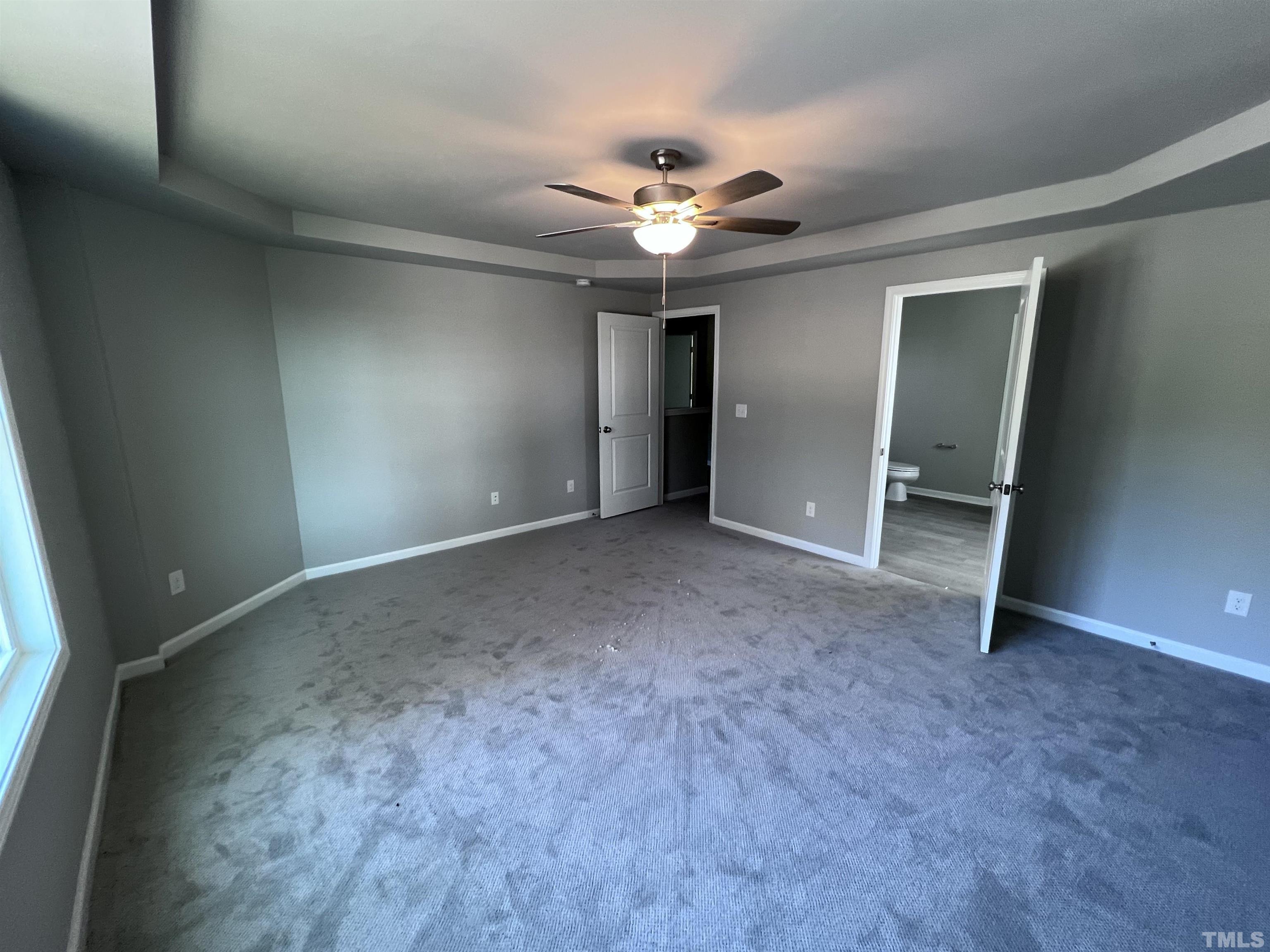 204 West Main Street Micro, NC 27576 - Photo 7 of 14 a view of an empty room with a ceiling fan