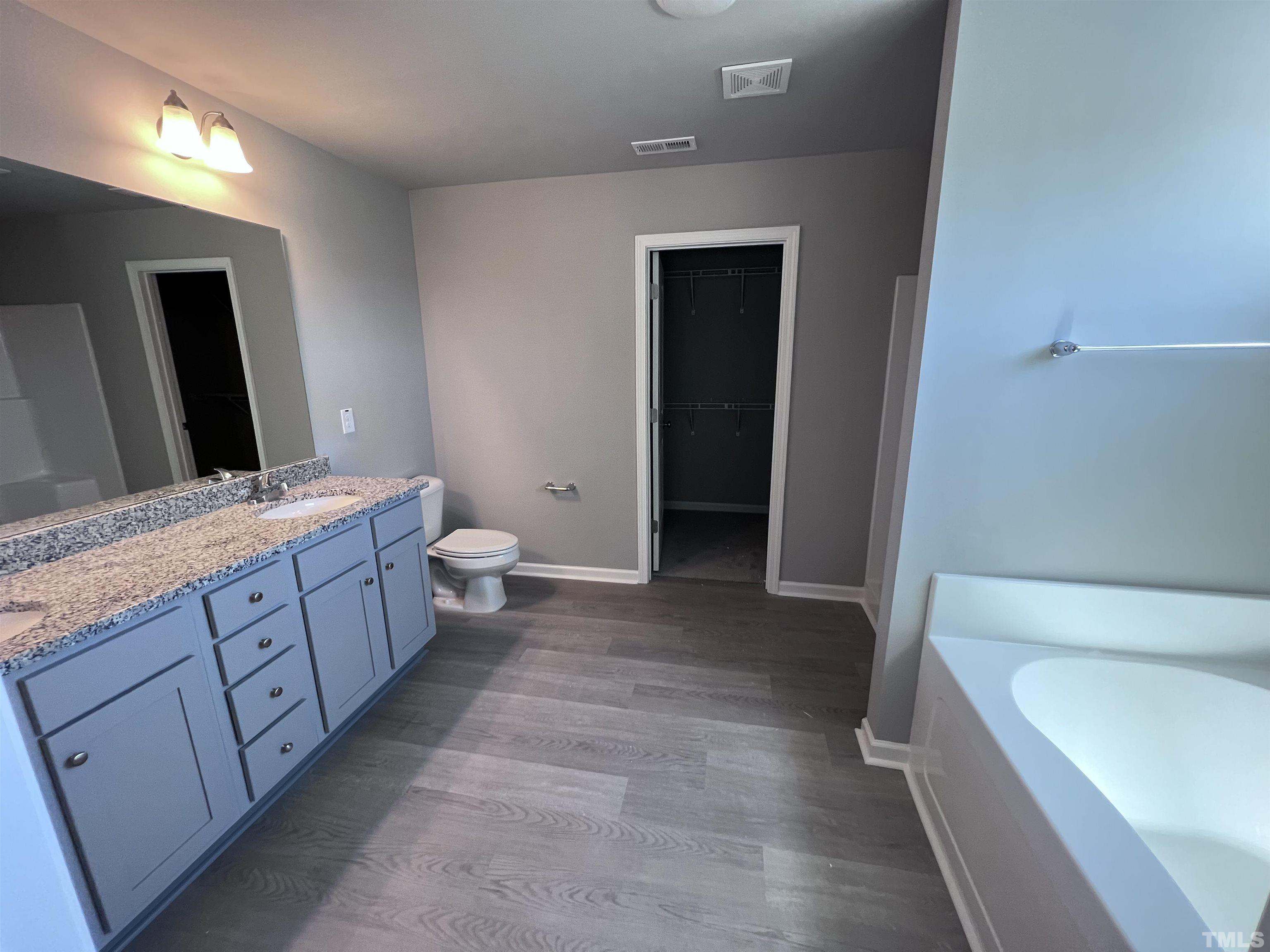 204 West Main Street Micro, NC 27576 - Photo 9 of 14 a bathroom with a double vanity sink and mirror with toilet