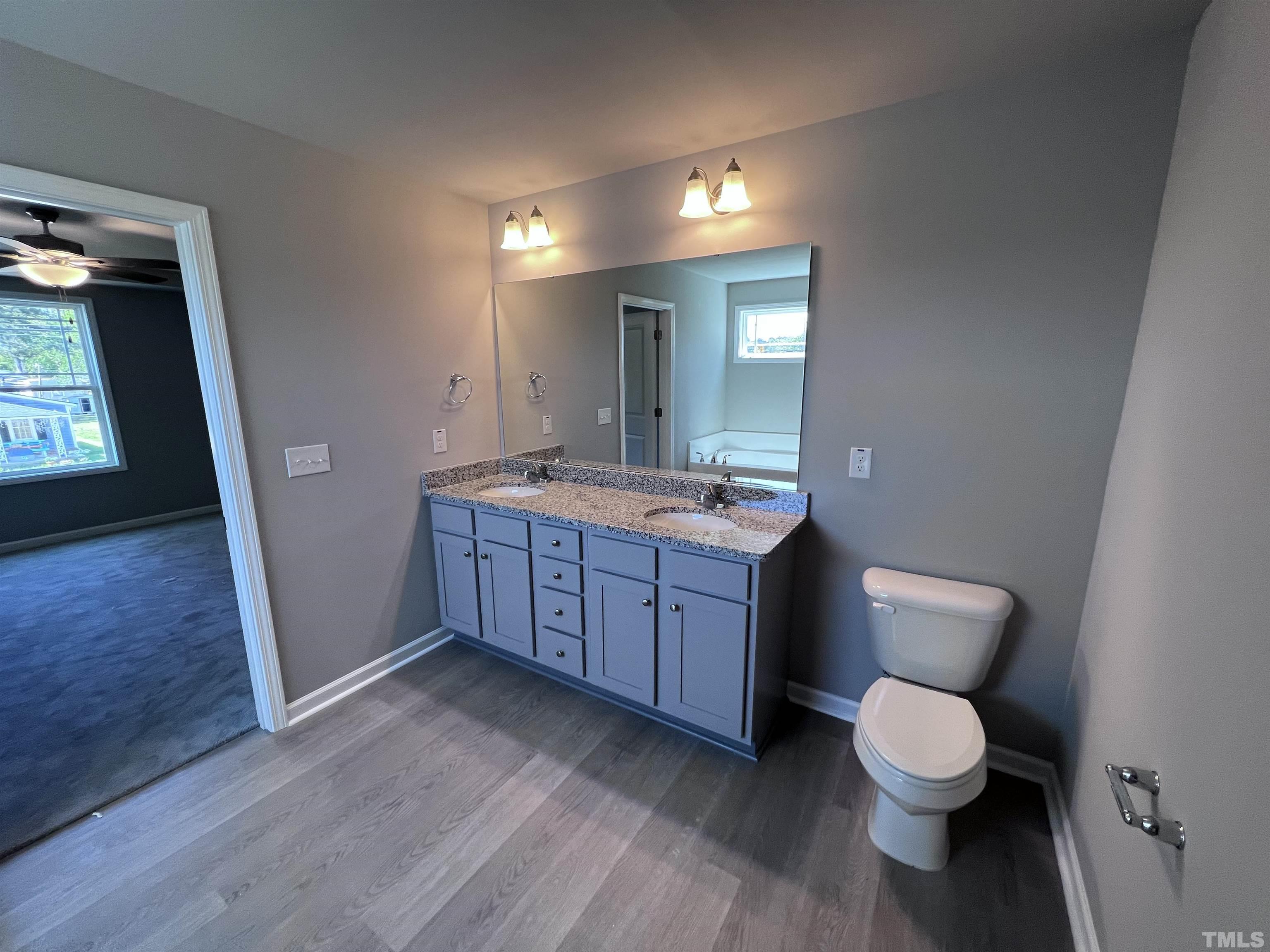 204 West Main Street Micro, NC 27576 - Photo 10 of 14 a bathroom with a toilet sink and mirror
