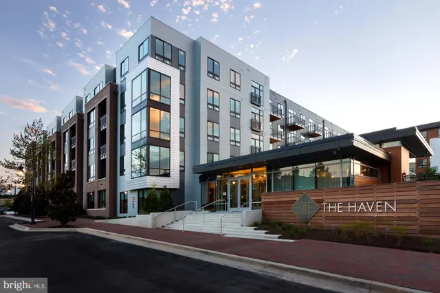 a front view of a building with a garden