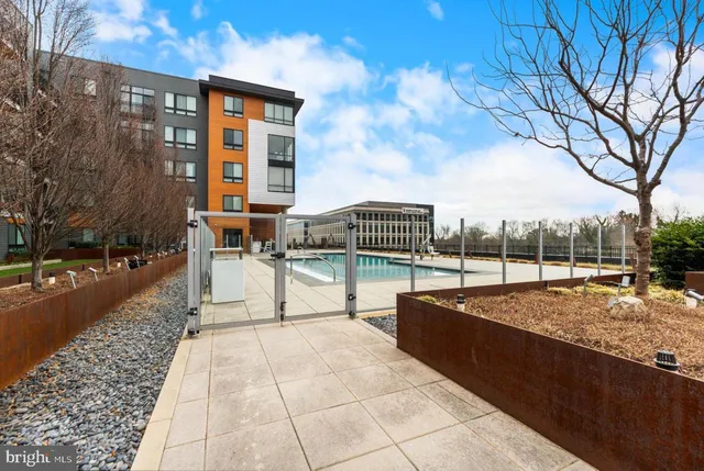 a view of house with a swimming pool and outdoor seating