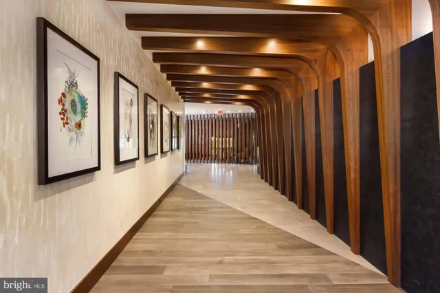 a living room with a large window wooden floor and a table
