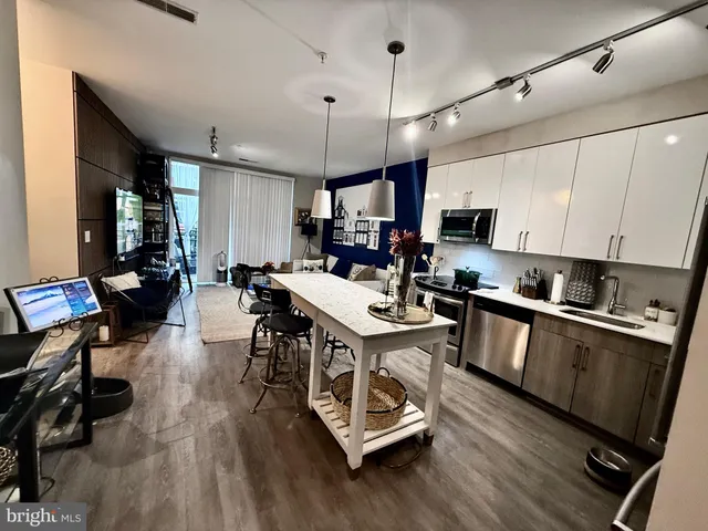 a living room with furniture and a lamp