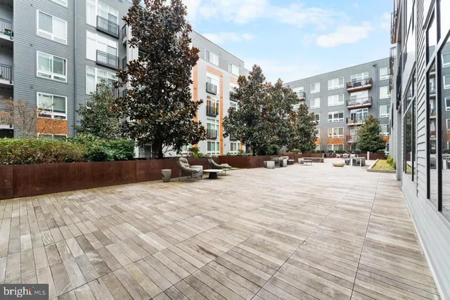 a view of roof deck with seating space and wooden floor