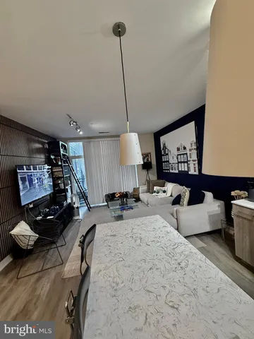 a kitchen with kitchen island granite countertop a sink a counter space appliances and cabinets