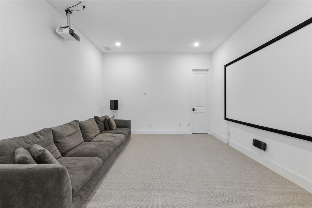 566 Broadleaf Way Haslet, TX 76052 - Photo 21 of 38 Dedicated media room featuring a large projection screen, ceiling-mounted projector, and recessed lighting