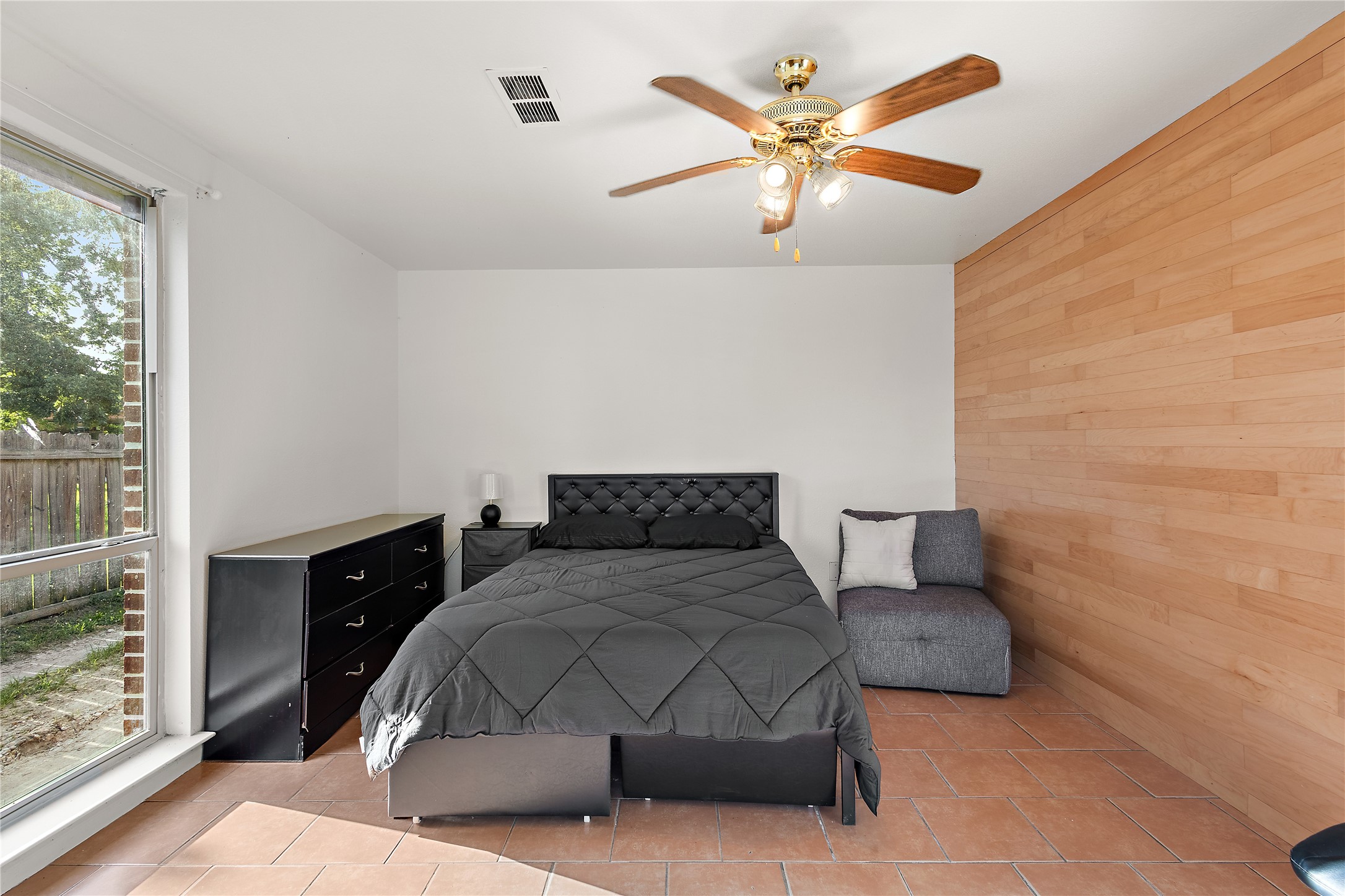 225 Palmyra Street Houston, TX 77022 - Photo 7 of 11 Living room converted into Well-appointed primary bedroom featuring stylish furnishings and a spacious layout designed for everyday comfort.