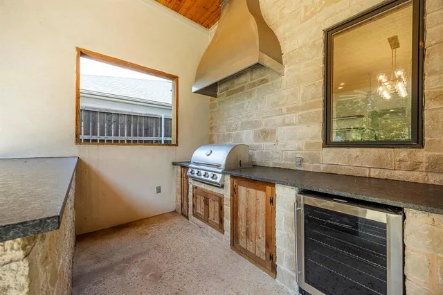 a kitchen with granite countertop a stove and a sink