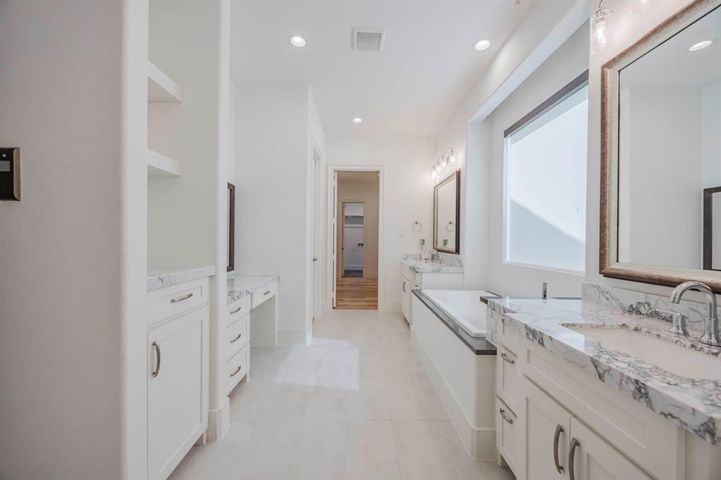 2081 Holt Way Grapevine, TX 76051 - Photo 18 of 39 a spacious bathroom with a double vanity sink a large mirror and a shower