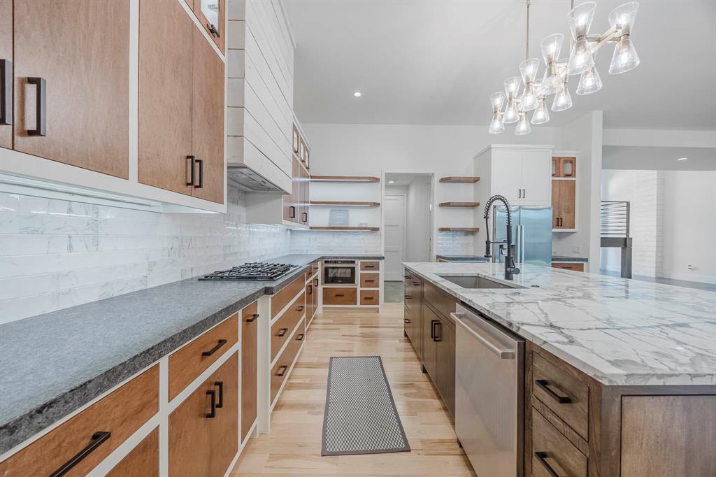 2081 Holt Way Grapevine, TX 76051 - Photo 8 of 39 a kitchen with stainless steel appliances granite countertop a kitchen island a stove and a sink