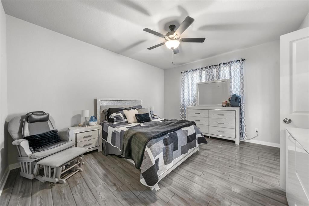 3525 Beutel Road Lorena, TX 76655 - Photo 11 of 34 a bedroom with a bed and wooden floor