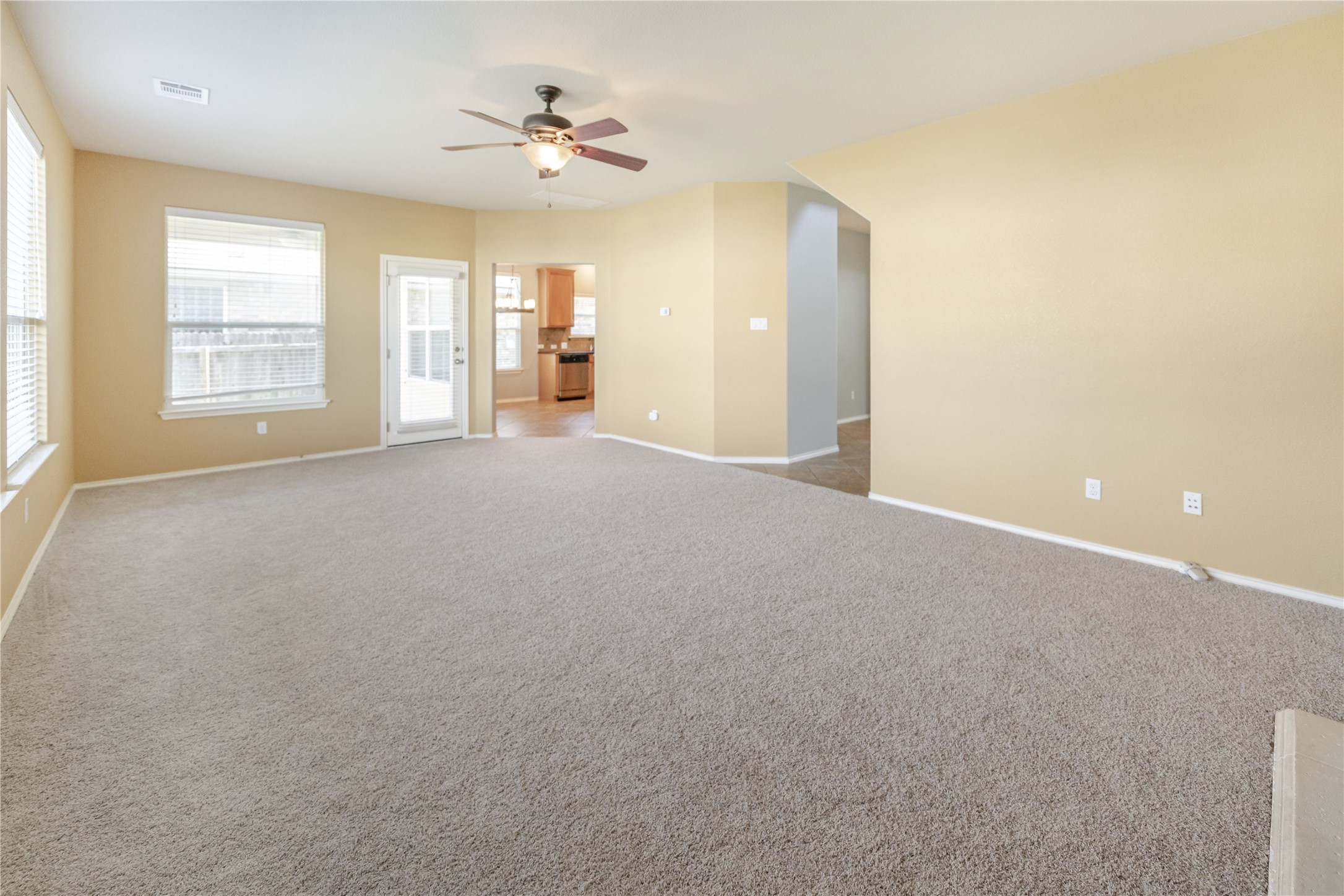11221 Old Quarry Road Austin, TX 78717 - Photo 6 of 19 Plush carpeting and abundant natural light define this versatile open living space.