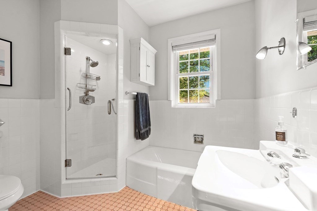 44 Rolling Lane Newton, MA 02467 - Photo 13 of 18 a bathroom with a tub a sink and a window